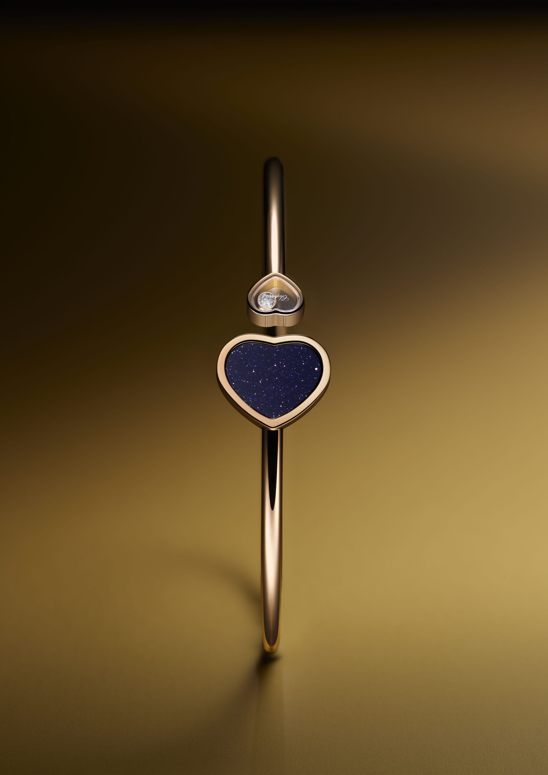 Happy Hearts Bangle in ethical 18-carat rose gold featuring a blue aventurine heart and a small heart with a dancing diamond ©Fédéral-Studio
