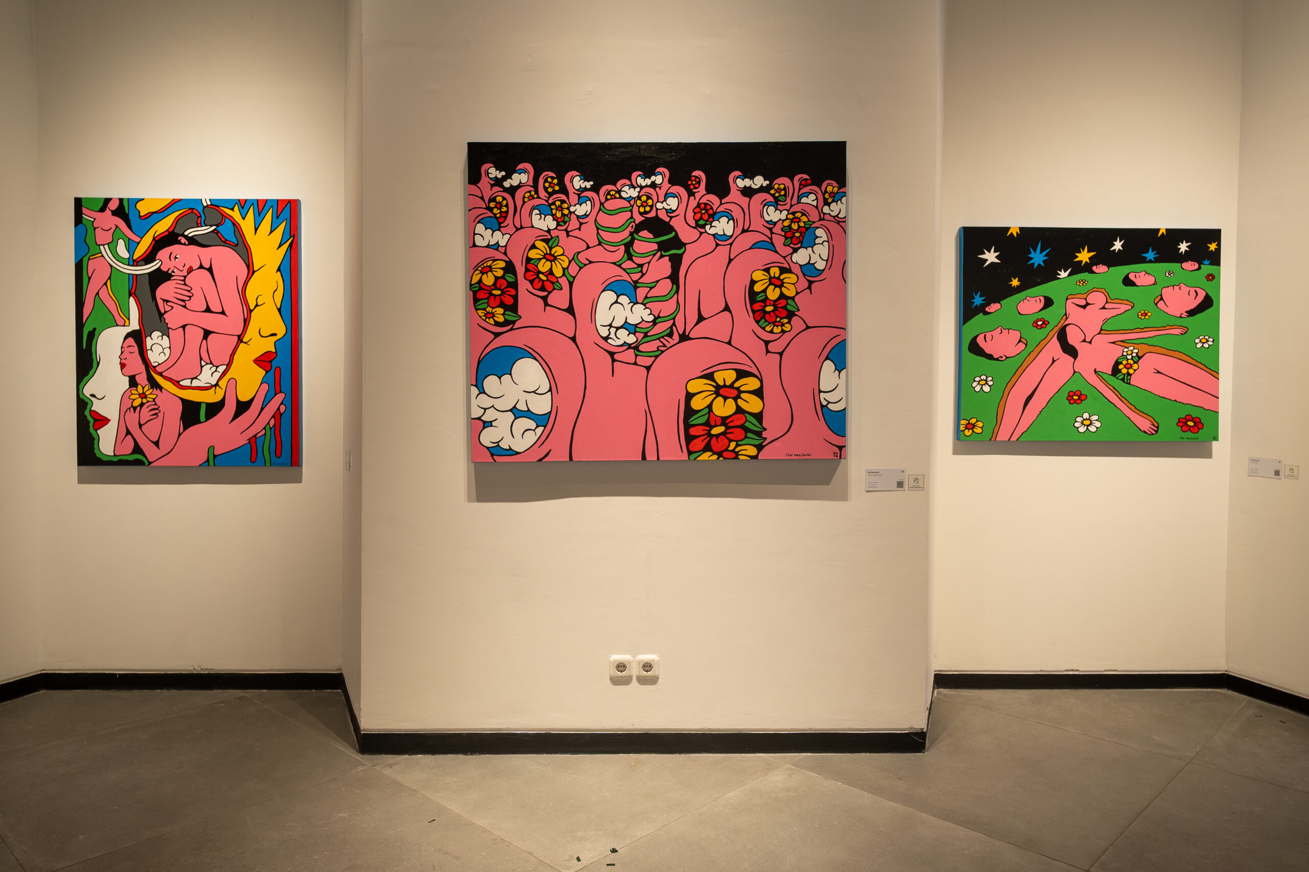 Inside the gallery, vivid portraiture and mixed-media works sit alongside smaller conceptual pieces, offering visitors contrasting visual languages within the two concurrent exhibitions.