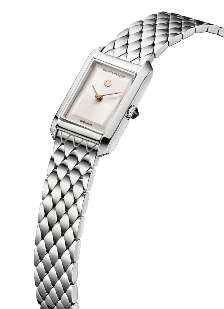 A close-up of the Hampton XS on its diamond-shaped steel bracelet. The silver sunray dial shows rose-gold hands and the Phi logo. Light traces the bracelet's repeating geometric links.