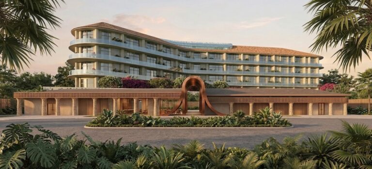 An architectural rendering of Bloom Hotel Bali Ungasan. Curved balconies wrap a tiled, terracotta-roofed building. A sculptural wooden archway anchors the entrance, framed by lush tropical palms.